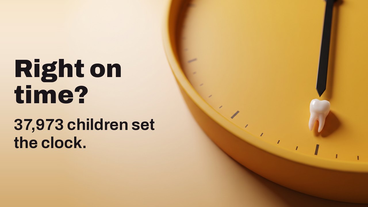Right on time? 37,973 children set the clock. A tiny baby tooth resting at the six o’clock mark of a saffron yellow clock face without numerals.