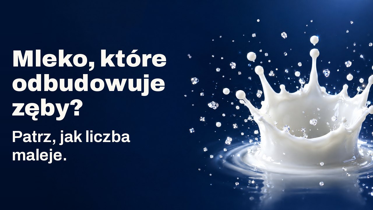 Mleko, które odbudowuje zęby? Patrz, jak liczba maleje. Korona z kropli mleka zastygła w powietrzu wśród drobnych lśniących kryształków, na granatowym tle.