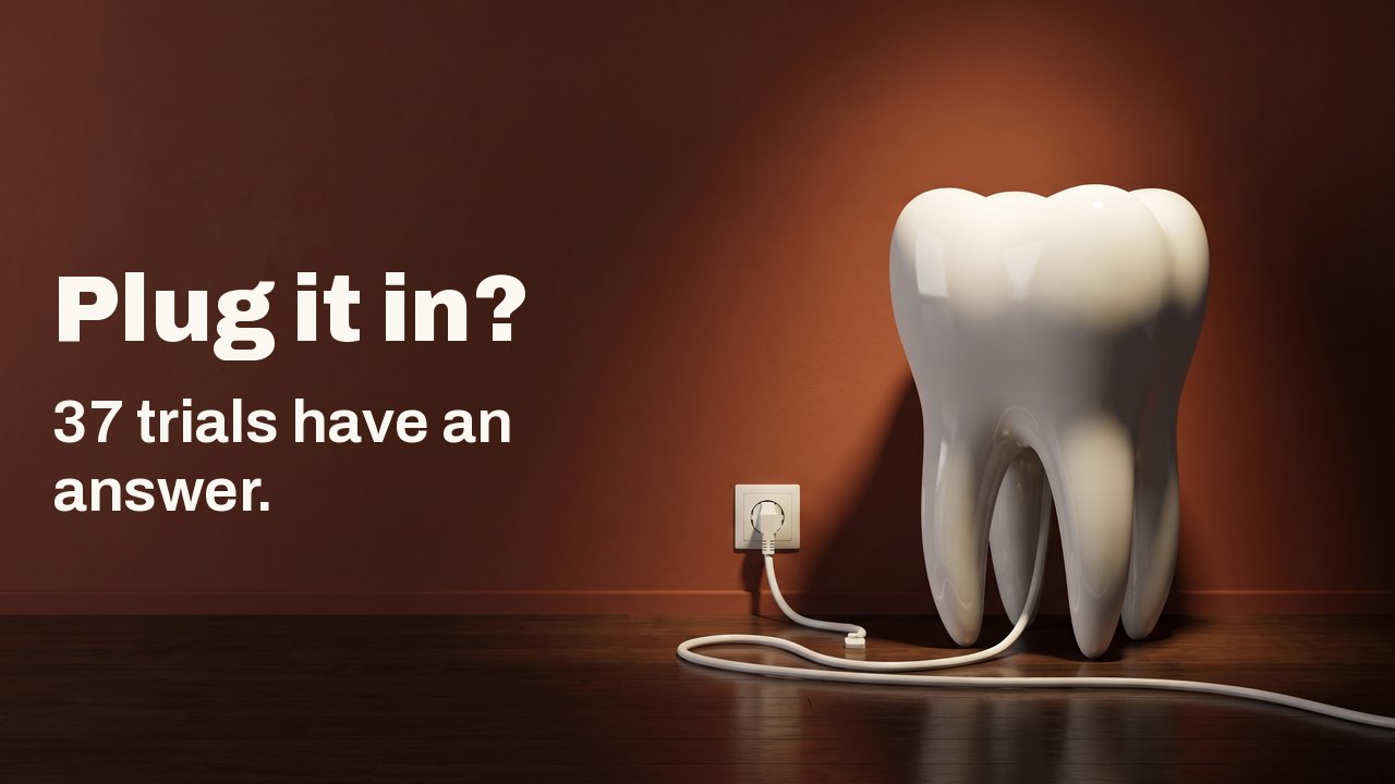Plug it in? 37 trials have an answer. A white porcelain model tooth on a wooden floor against a terracotta wall, its white cable plugged into a wall socket.